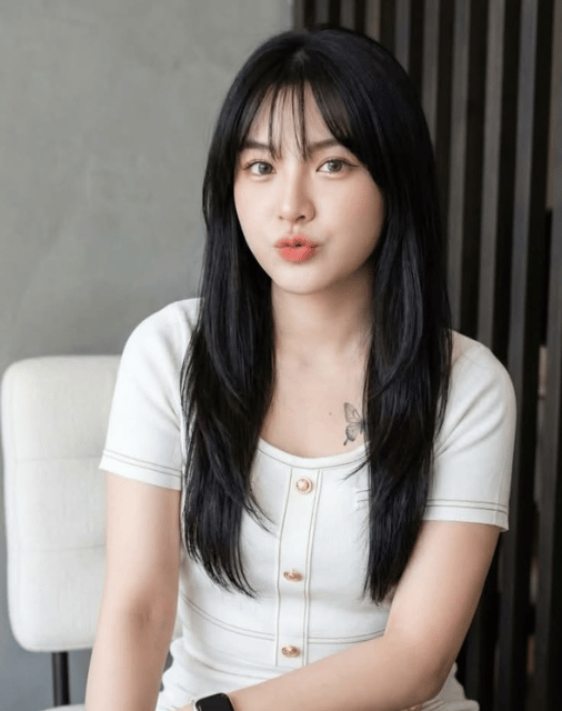 woman in white and black striped shirt